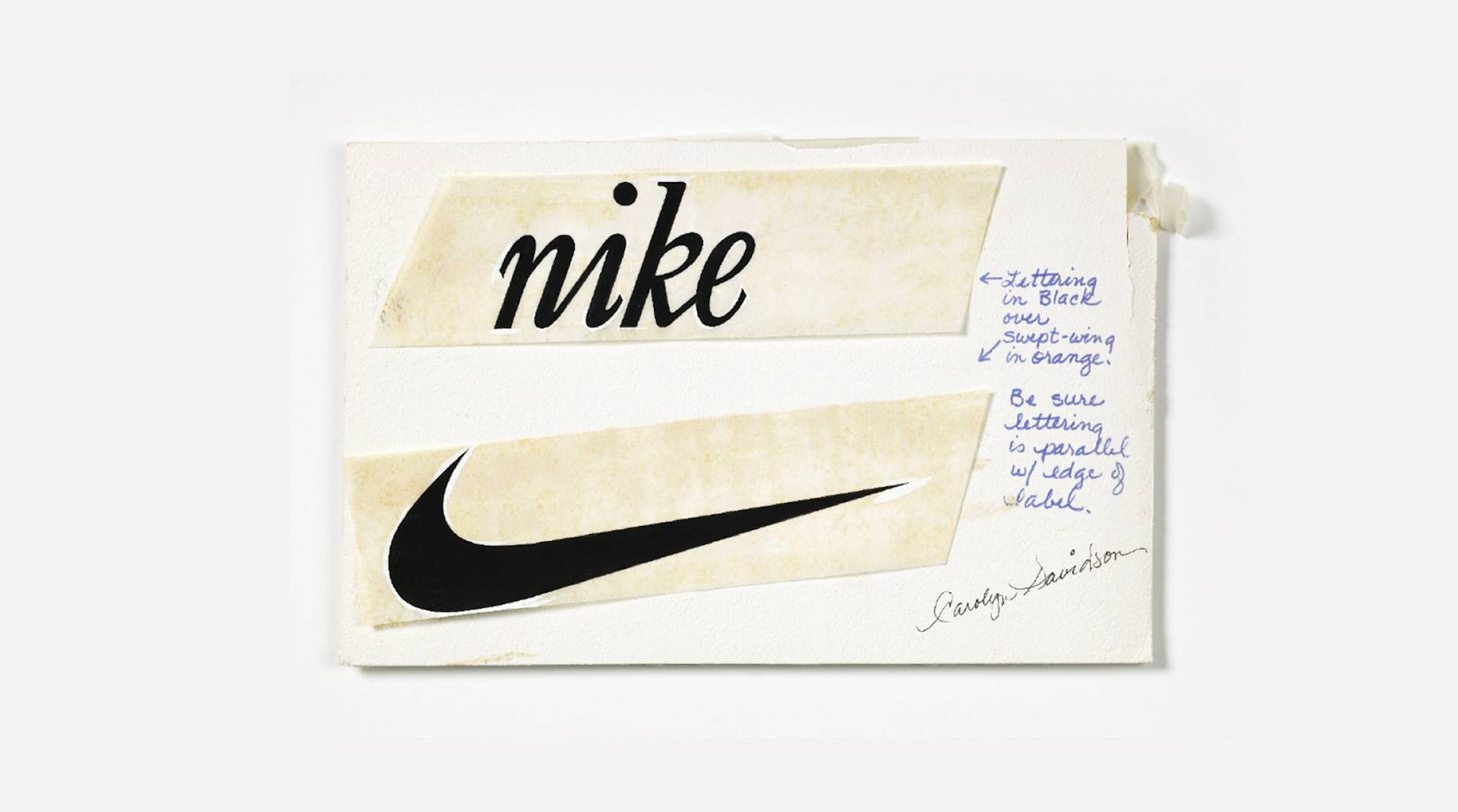 A handwritten design sketch featuring the word nike and the Nike Swoosh logo, with notes in blue ink about lettering colors and placement, signed by Carolyn Davidson.