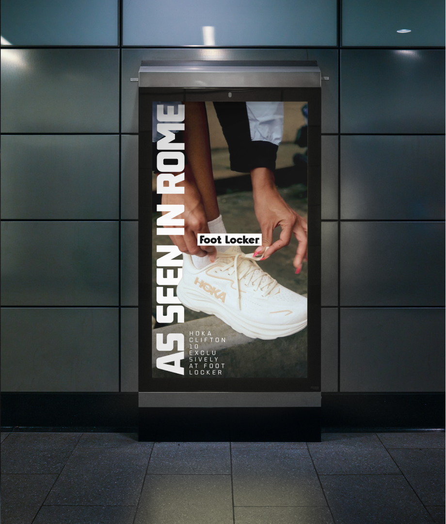 An ad in a subway station shows a close-up of hands tying the laces of a white HOKA sneaker. The text reads AS SEEN IN ROME and HOKA Clifton 9, see it, revel at Foot Locker. The Foot Locker logo is centered.