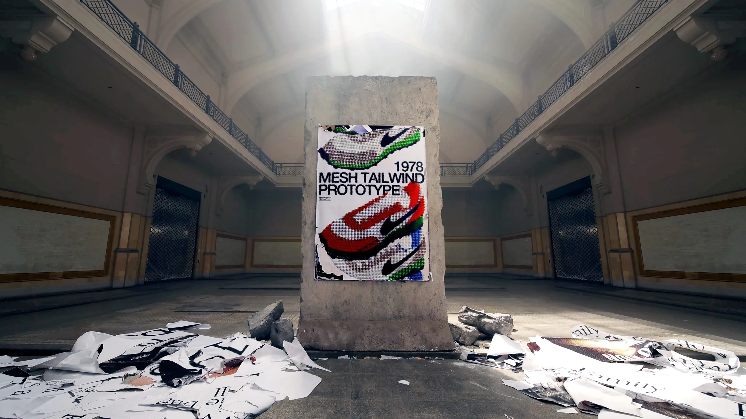 A concrete slab stands in the center of a large, empty hall, displaying a colorful poster with Nike shoes and the text 1978 Mesh Tailwind Prototype. Torn posters and debris are scattered on the floor around it.
