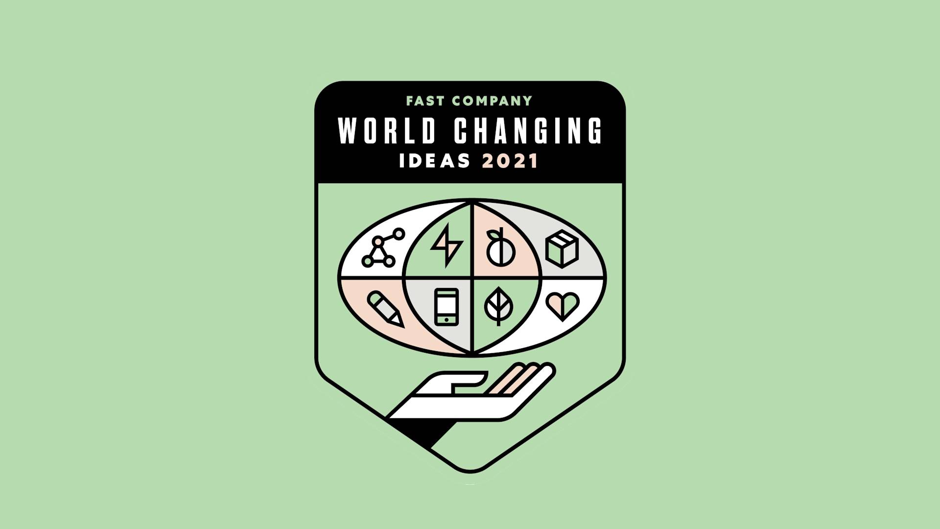 A badge with Fast Company World Changing Ideas 2021 featuring icons of science, energy, food, health, environment, and a pencil, above a stylized hand on a light green background.