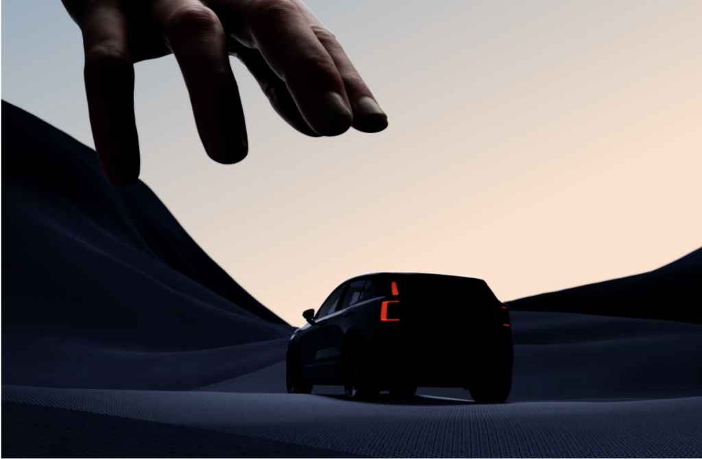A large hand hovers above a dark SUV driving through abstract, wavy terrain at dusk, creating a dramatic, surreal scene with soft light in the sky.