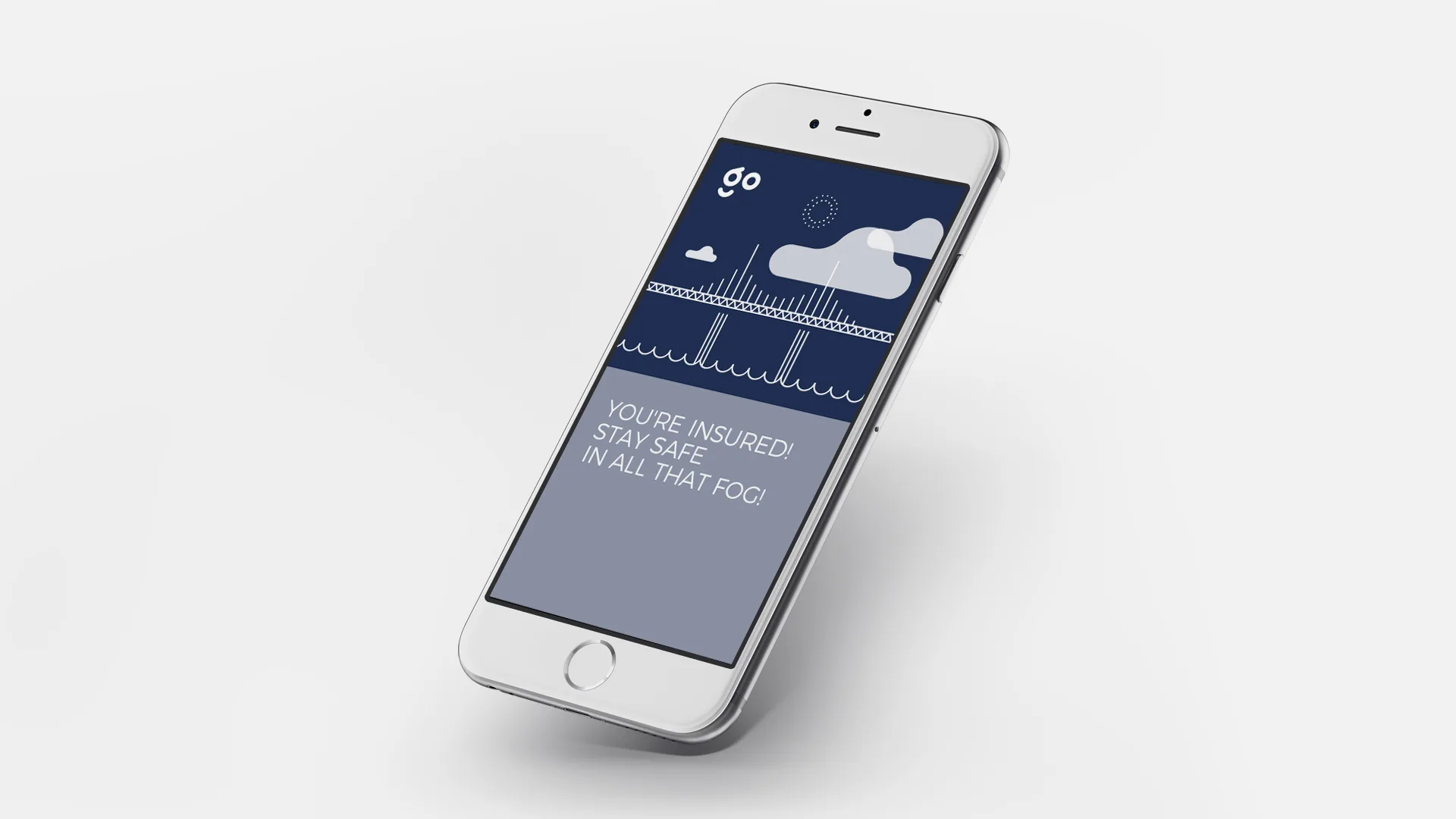 A smartphone displays an insurance app screen showing a bridge in fog, clouds, and a safety message: “YOU’RE INSURED! STAY SAFE IN ALL THAT FOG!” The phone is tilted and set against a white background.