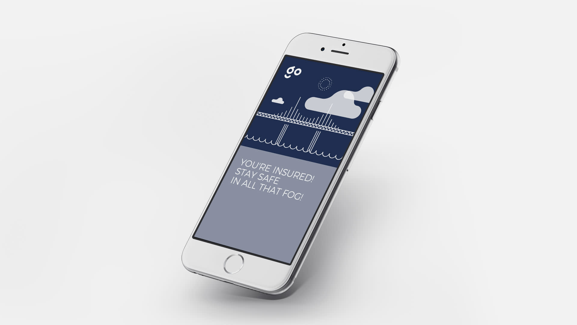 A smartphone displays an insurance app screen showing a bridge in fog, clouds, and a safety message: “YOU’RE INSURED! STAY SAFE IN ALL THAT FOG!” The phone is tilted and set against a white background.