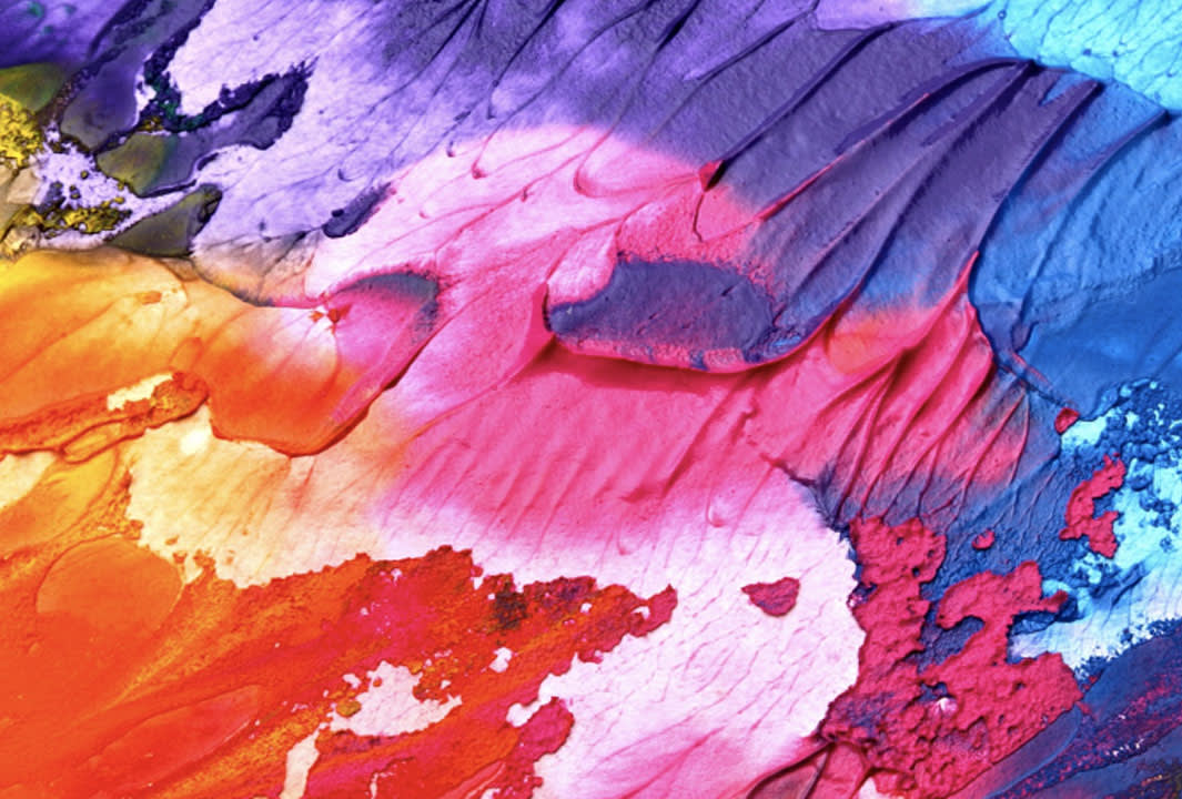 Abstract image featuring bold, textured brushstrokes in vibrant colors, including purple, blue, pink, red, orange, and yellow, blending and overlapping in a dynamic, painterly composition.