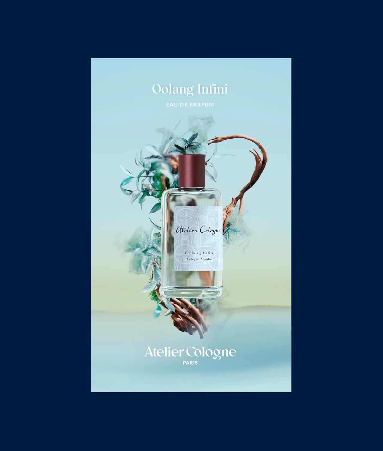 A bottle of Atelier Cologne’s Oolang Infini Eau de Parfum is surrounded by blue flowers and twirling branches on a light blue background. “Atelier Cologne Paris” is written at the bottom.