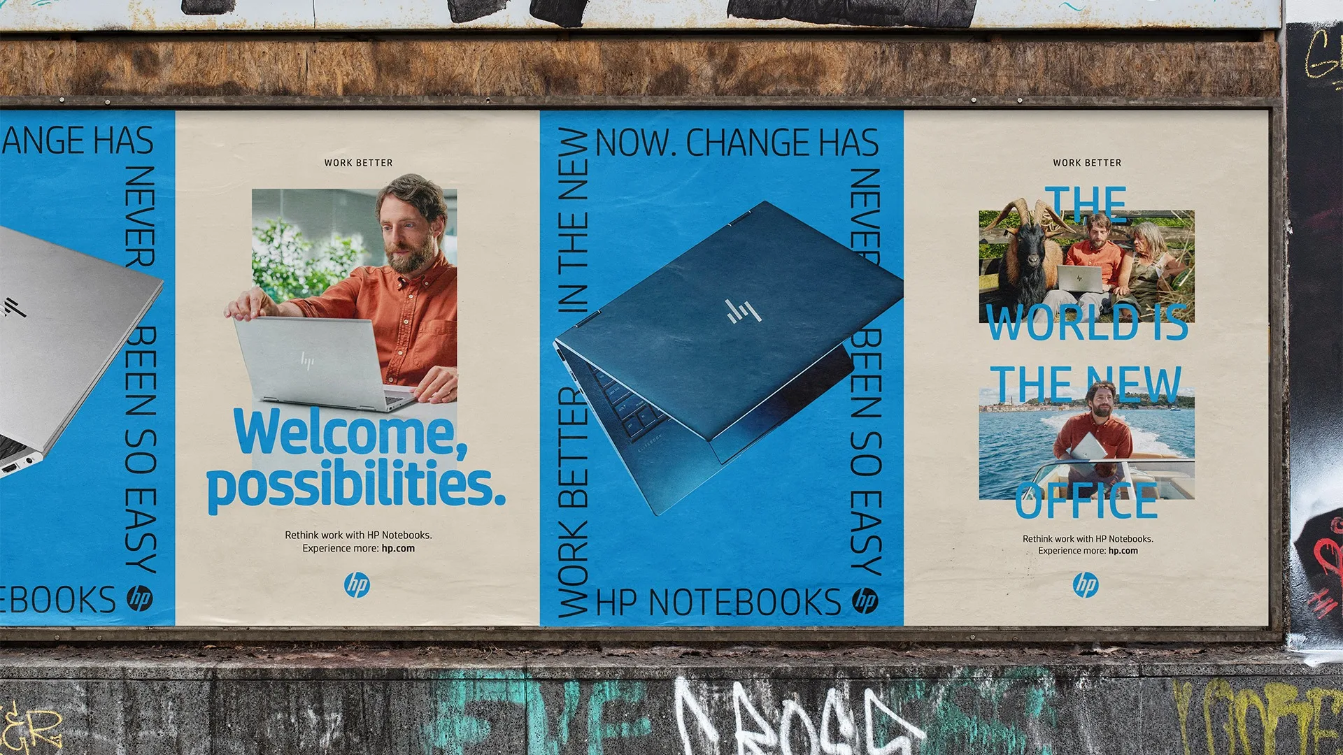 Three posters on a wall promote HP Notebooks, featuring a man using a laptop, a close-up of an HP notebook, and the man working outdoors with the text: Welcome, possibilities and The world is the new office.