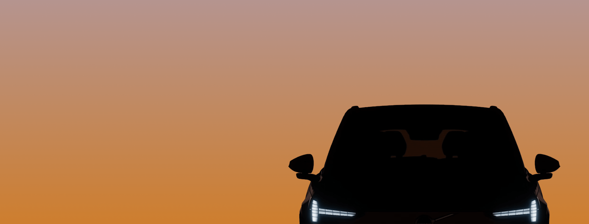 A black car with headlights on is seen from the front against a gradient orange and purple sunset sky, occupying the lower right corner of the image.