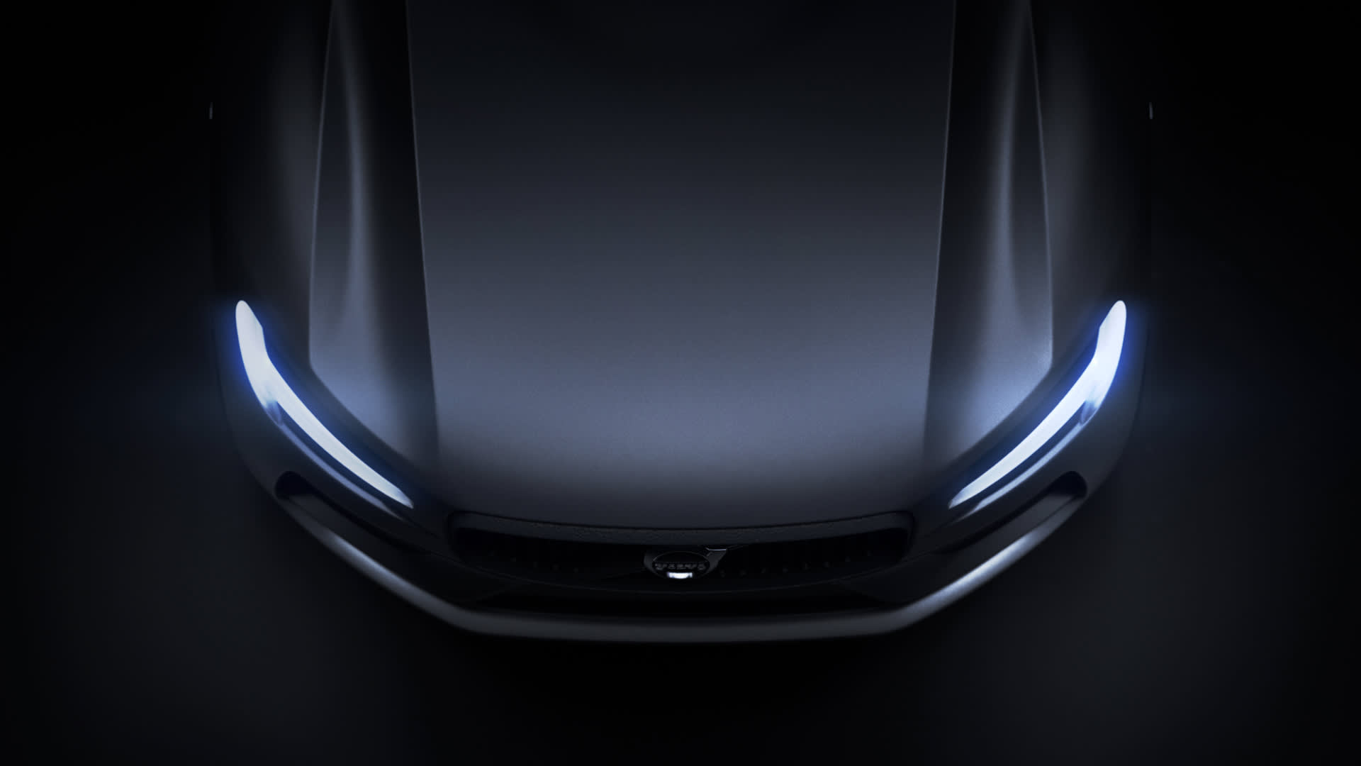 A top-down view of a dark-colored car, illuminated by sleek, bright LED headlights, emphasizing the smooth curves of the hood and minimalist front grille.