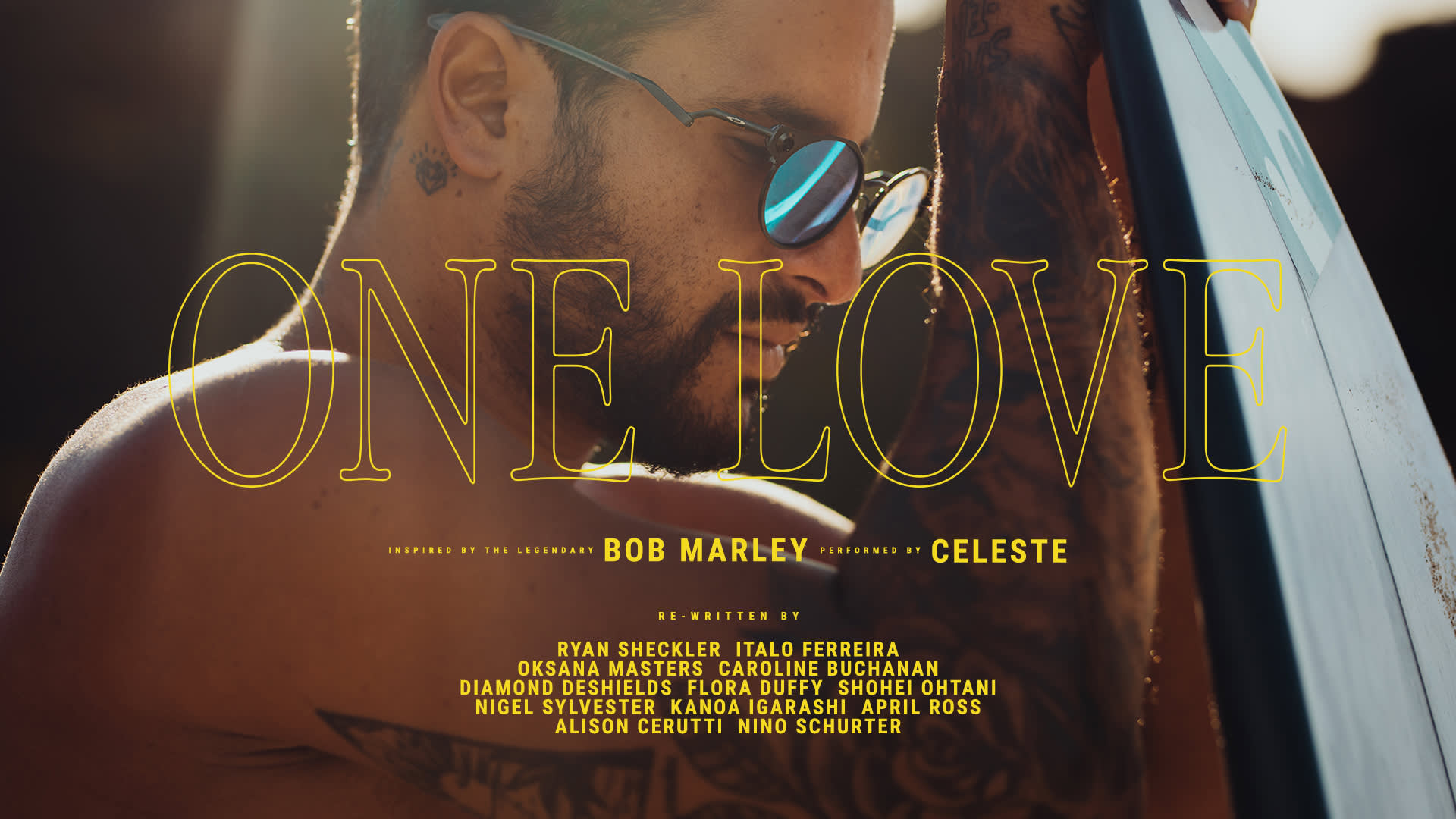 A tattooed man wearing sunglasses and smiling leans on a surfboard under bright sunlight. Large text reads ONE LOVE. Additional credits include Bob Marley, Celeste, and various names in smaller text.