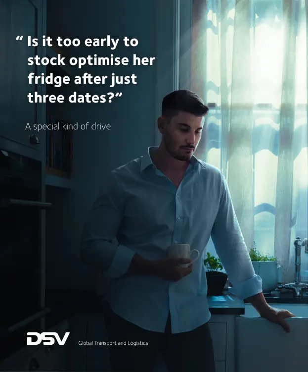A man holding a mug leans on a kitchen counter by a sunlit window. Text beside him reads: Is it too early to stock optimise her fridge after just three dates? A special kind of drive. DSV logo is at the bottom.