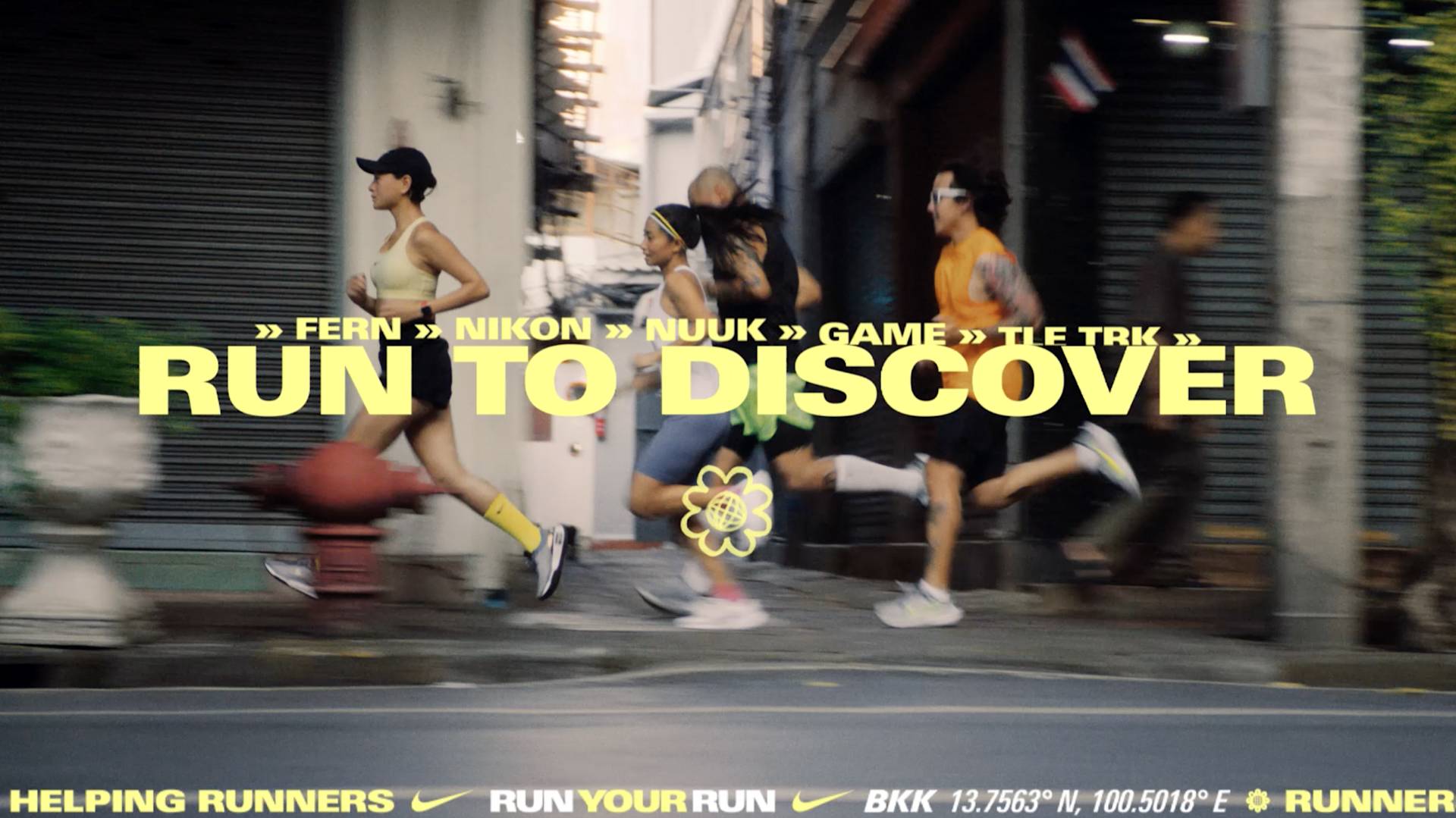 Four people in athletic wear run down a city street past closed shop fronts. Overlay text reads Run to Discover with runners names and location info. The Nike logo and slogan appear at the bottom.