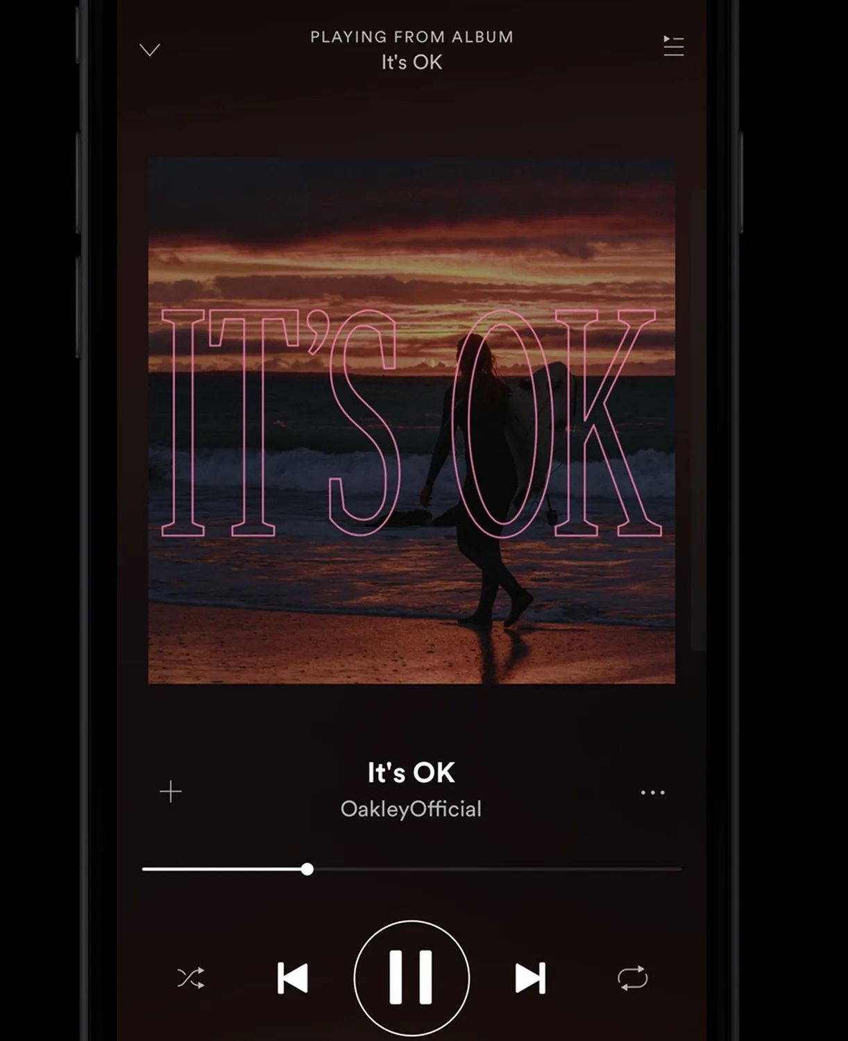 A music player screen displays the song Its OK by OakleyOfficial, showing a cover image of a person walking on a beach at sunset with large pink text reading ITS OK over the scene.