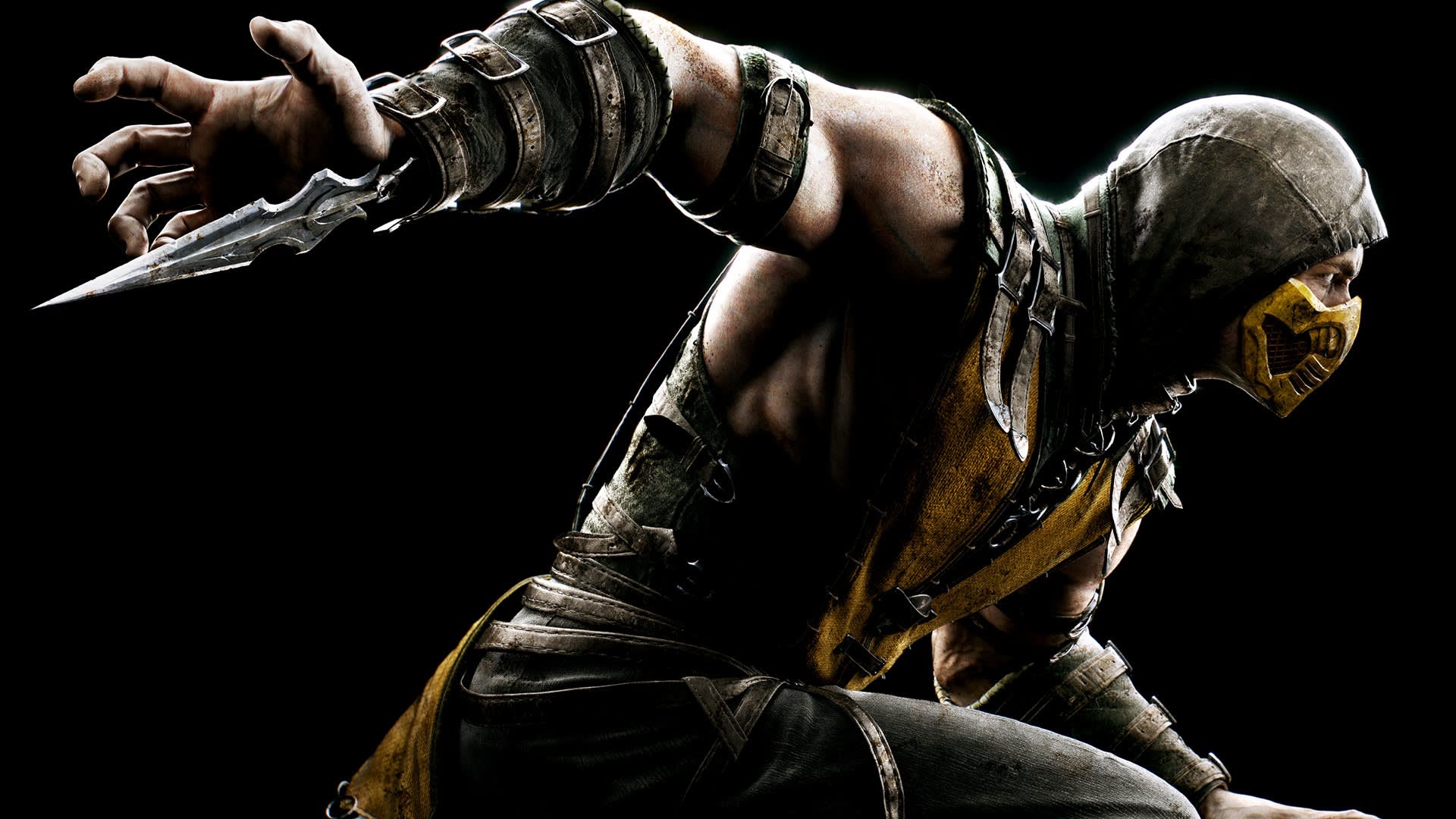 A muscular warrior in a yellow and black outfit, hood, and mask crouches with an arm extended, holding a bladed weapon. The background is black, highlighting his intense and ready-for-battle pose.