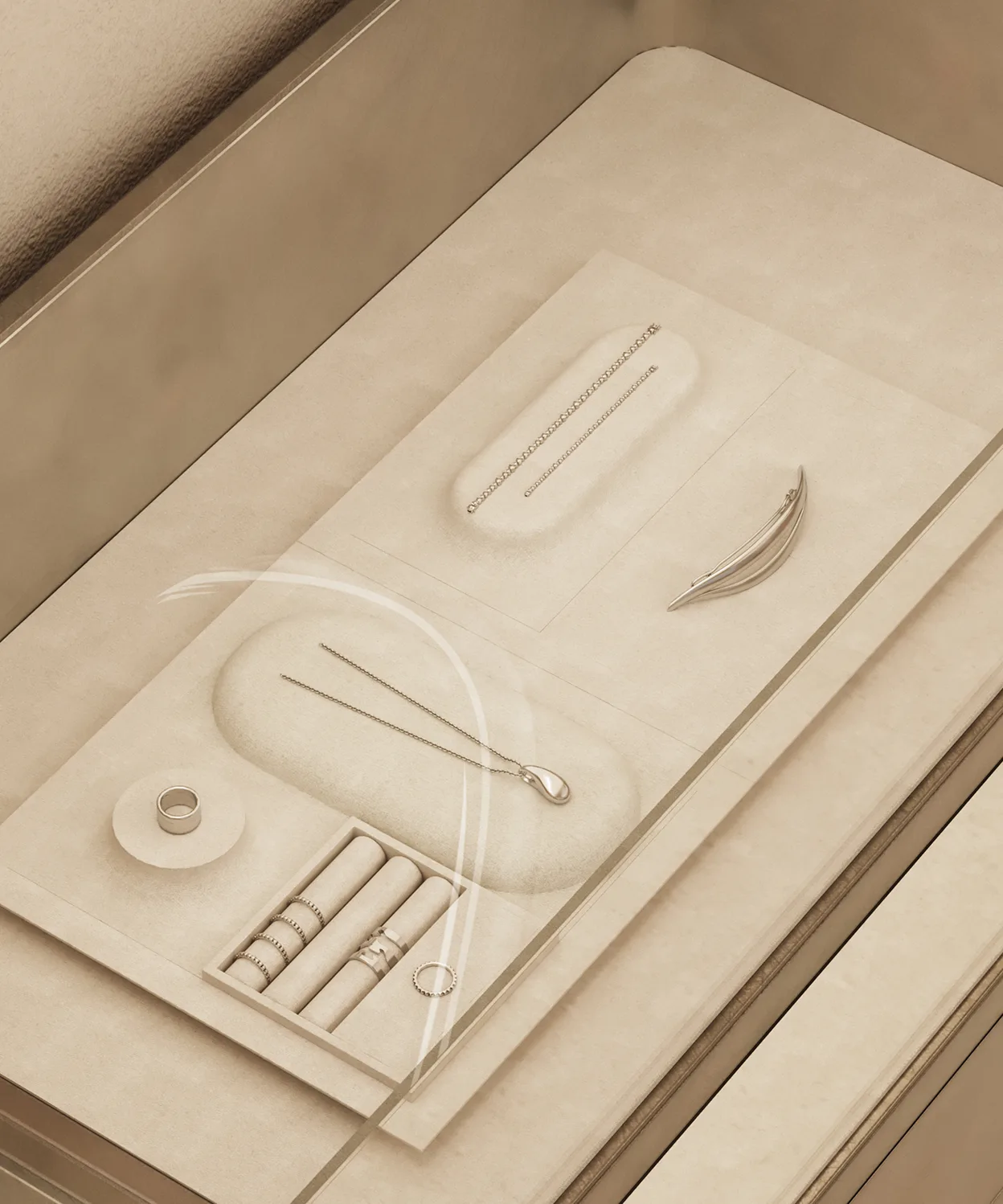 A glass-topped jewelry drawer displays rings, a bracelet, a necklace, and a brooch organized neatly in a beige velvet organizer. The drawer is built into a beige cabinet.