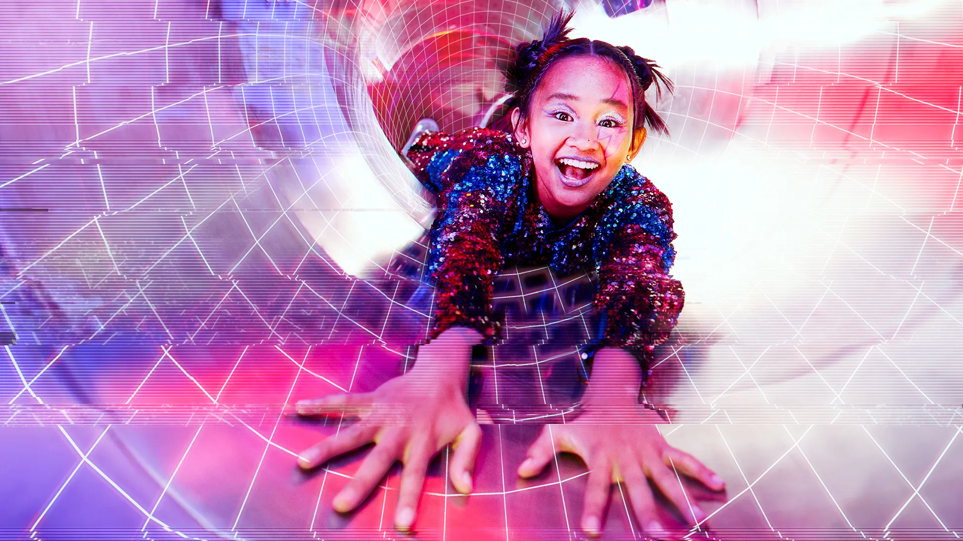 A smiling child in a sparkly outfit slides down a brightly lit tunnel, reaching out with both hands. Overlaid digital grid patterns add a futuristic, dynamic effect to the colorful scene.