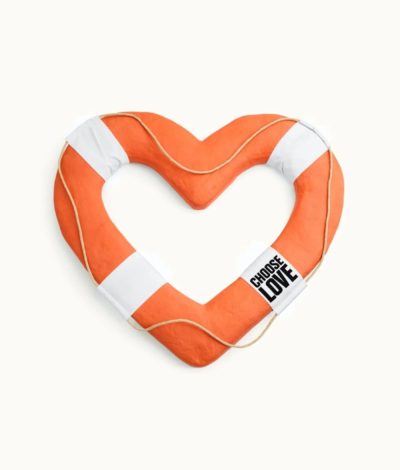 Heart-shaped orange lifebuoy with white bands and a rope. One band features a label that reads CHOOSE LOVE. The lifebuoy is against a plain, light background.