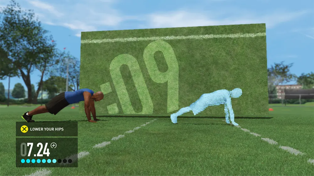 A person does a plank exercise on grass in front of a digital timer display, with a virtual figure next to them mirroring the pose. The screen shows “Lower Your Hips” and a timer at 7.24 seconds.
