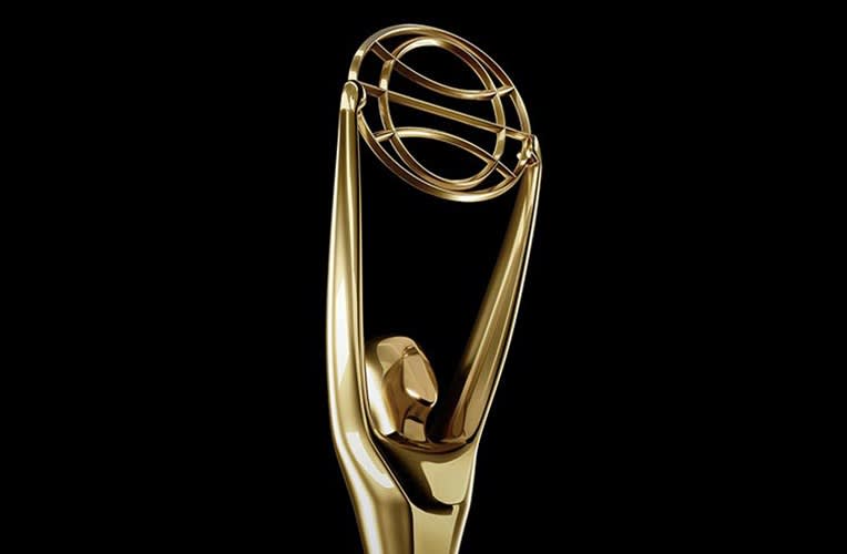 A gold trophy statue featuring a stylized human figure holding up a large ring, set against a plain black background.