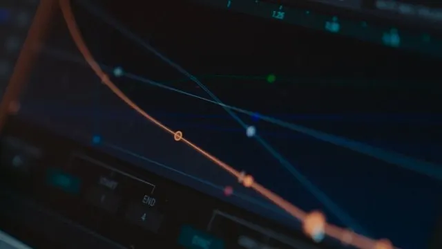 Close-up of a computer screen displaying a colorful line graph with intersecting curves and control points, likely from audio editing or data analysis software.