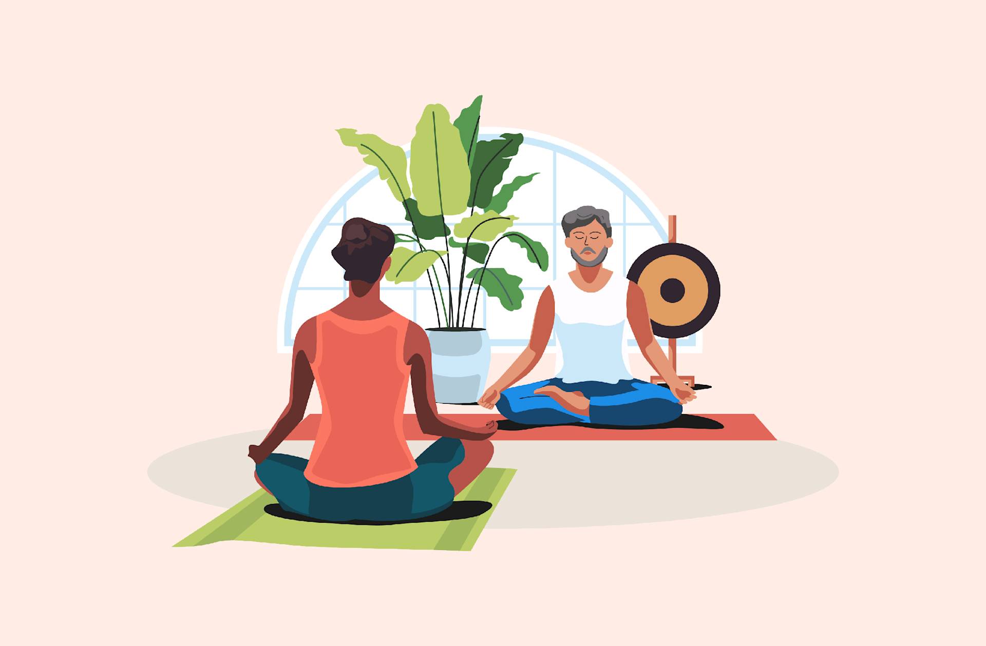 Two people sit cross-legged on yoga mats, facing each other and meditating indoors. A potted plant and a gong are in the background near a large arched window.