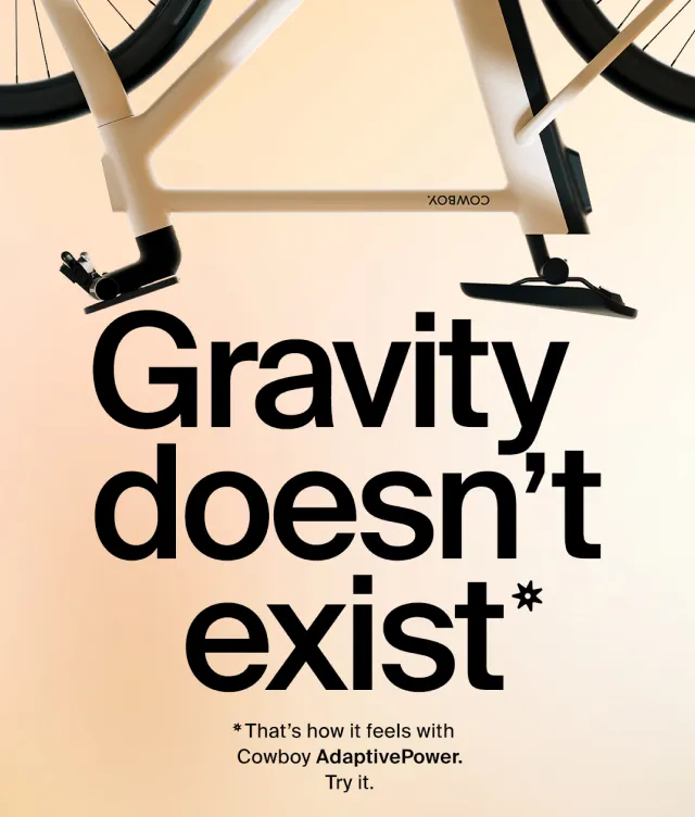 Partial image of a bicycle above bold text reading “Gravity doesn’t exist*.” Smaller text below says, “*That’s how it feels with Cowboy AdaptivePower. Try it.”.
