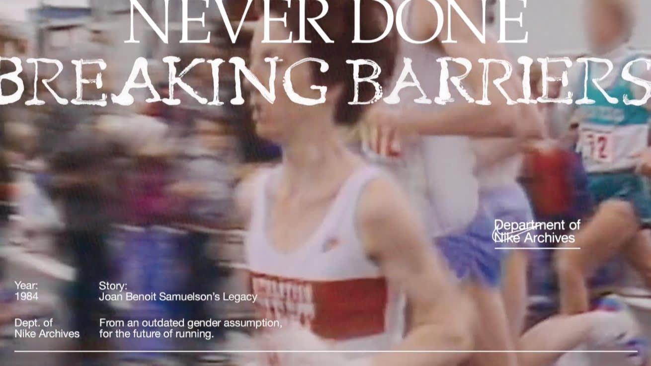 A blurred image of female marathon runners in athletic gear, overlaid with the text “NEVER DONE BREAKING BARRIERS.” Additional text includes a reference to Joan Benoit Samuelson’s legacy and the Nike Archives, with the year 1984 mentioned.
