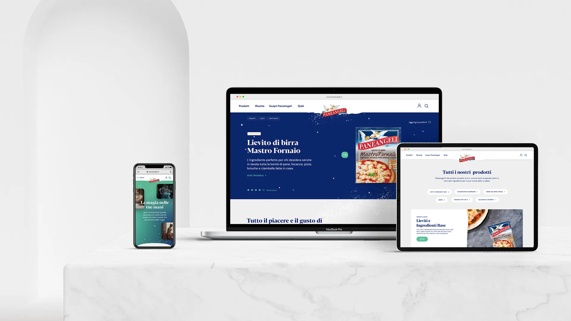 A smartphone, laptop, and tablet display different views of a website for a pizza ingredient brand, all placed on a white marble surface against a minimalist white background.