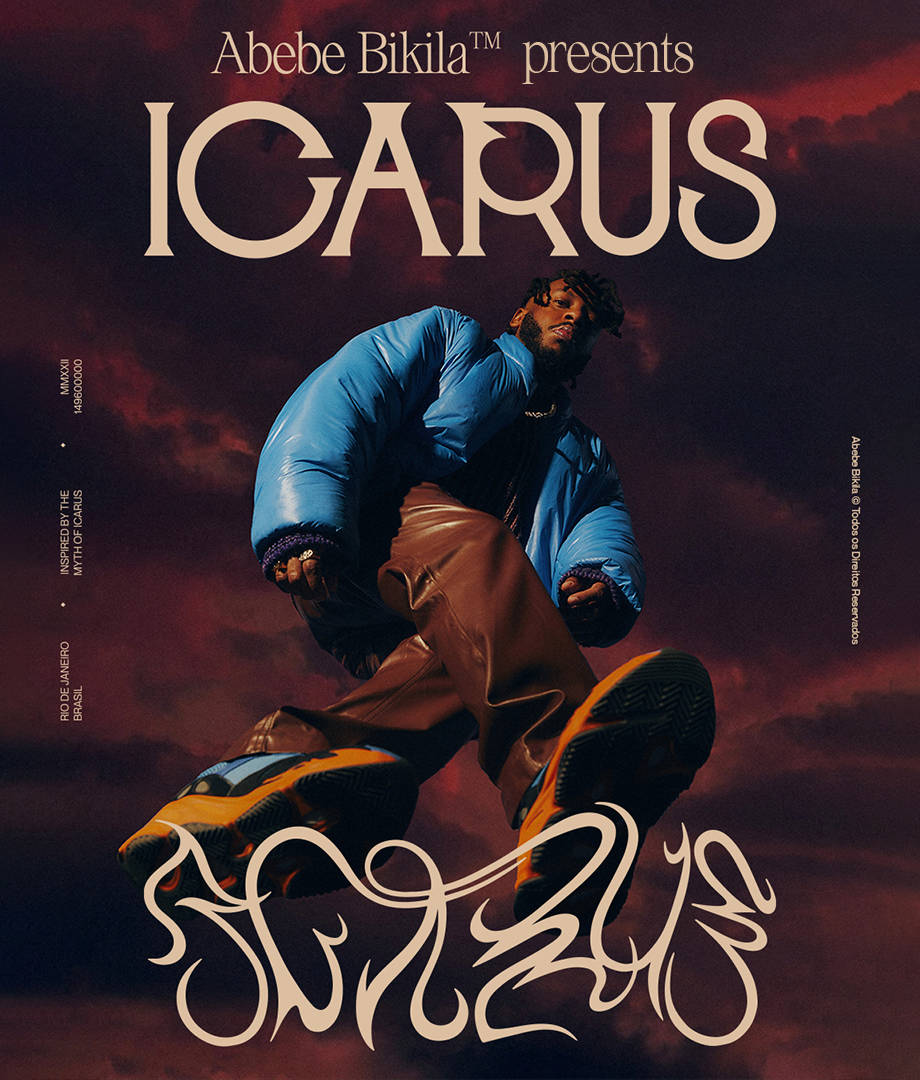 A person in a blue puffer jacket and brown pants poses with one foot forward against a dramatic, cloudy red sky. Large text reads Abebe Bikila™ presents ICARUS, with stylized graffiti at the bottom.