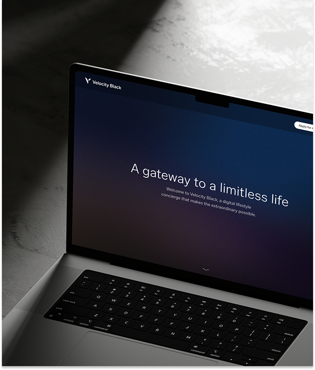 A laptop displaying a dark screen with the text A gateway to a limitless life. Welcome to Velocity Black, a digital lifestyle concierge that makes the extraordinary possible.