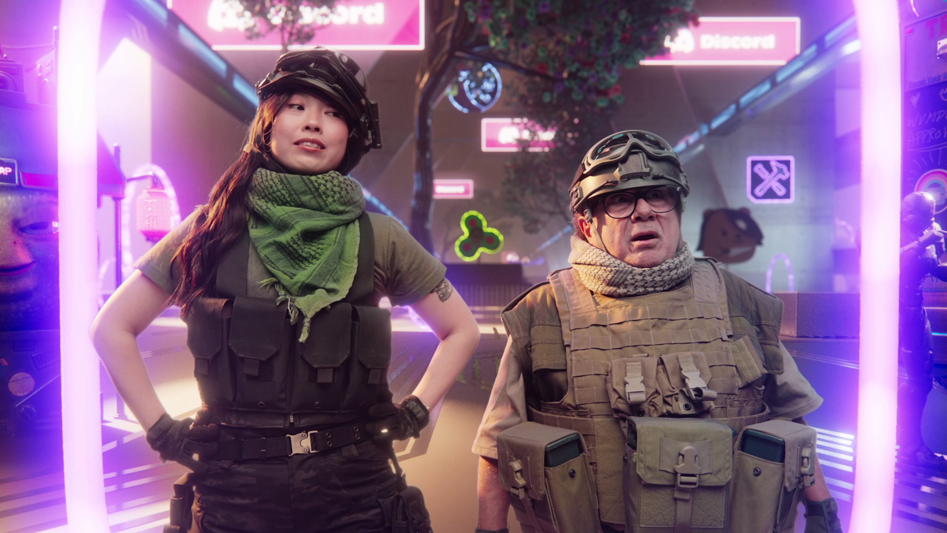 Two people in tactical gear and helmets stand in a neon-lit, futuristic setting with Discord logos and digital signs in the background, appearing alert and ready for action.