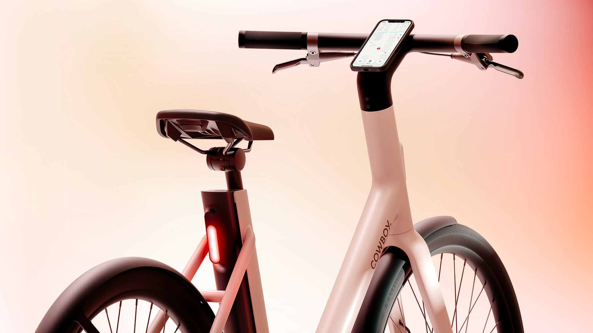 A sleek, modern electric bike with a smartphone mounted on the handlebars and a rear light glowing red, set against a gradient background of warm pastel colors.