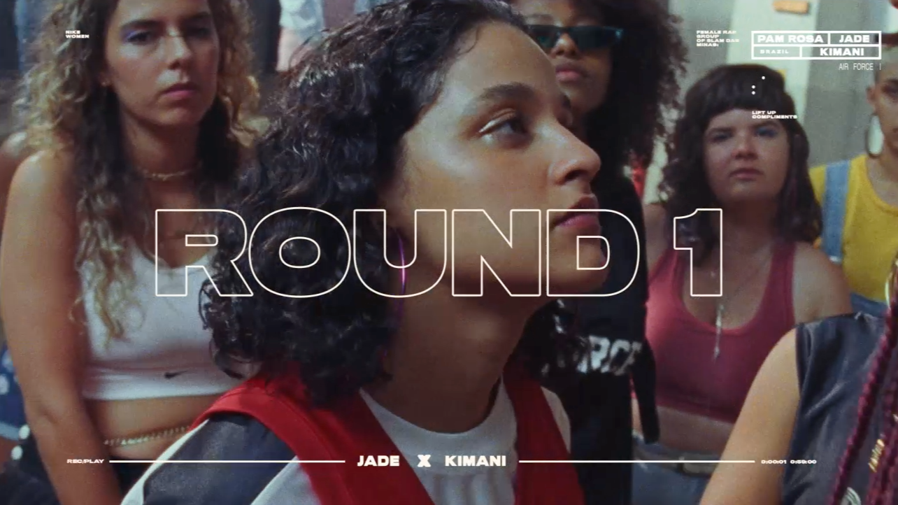 A group of young women watch intently indoors, with “ROUND 1” in large transparent letters over the center. Overlay text also reads “JADE X KIMANI” at the bottom and “PAM, ROSA, JADE, KIMANI” at the top right.