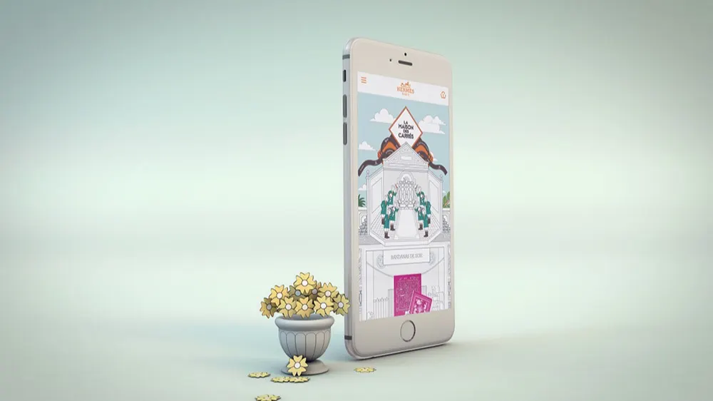A smartphone displaying an illustrated gate is standing upright next to a small decorative pot filled with yellow flowers, with some flowers scattered on the surface in front of a soft, light background.