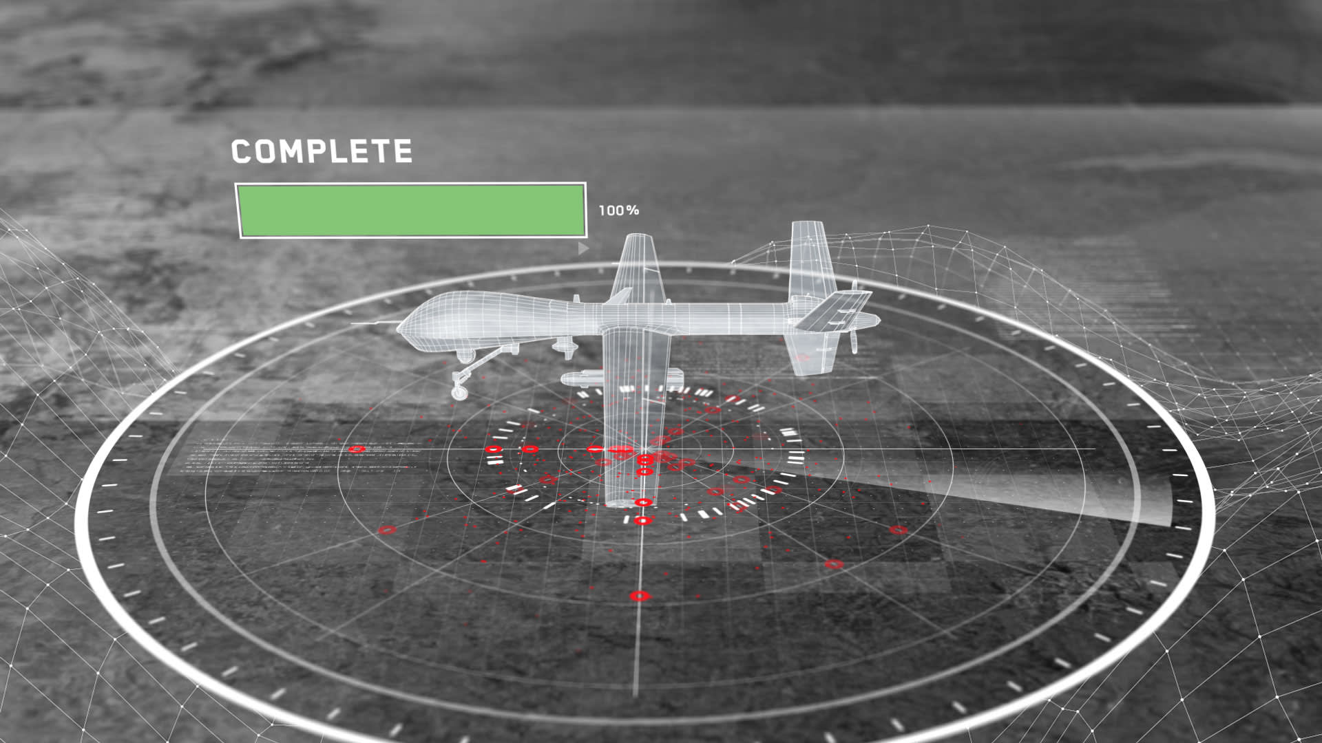 A digital interface shows a wireframe drone on a circular radar display with red markers. A green progress bar labeled COMPLETE is filled to 100% at the top left. The background is a grayscale aerial view.