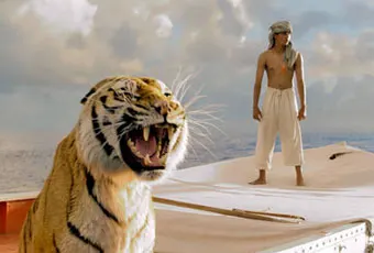A tiger growls on a boat at sea, while a young man in white pants and a cloth turban stands in the background, looking out over the water under a cloudy sky.