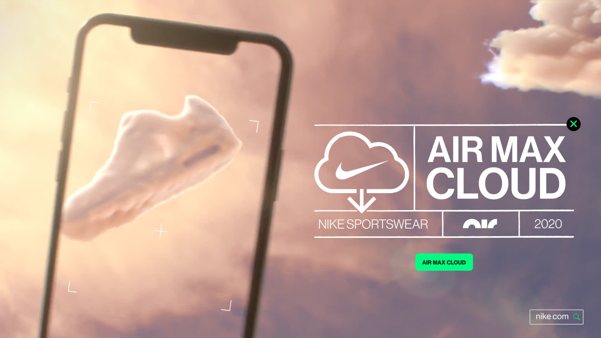 A fluffy cloud shaped like a Nike Air Max shoe floats in a pink sky, viewed through a smartphone screen. Text reads Air Max Cloud, Nike Sportswear, 2020 with cloud and Nike logo graphics.