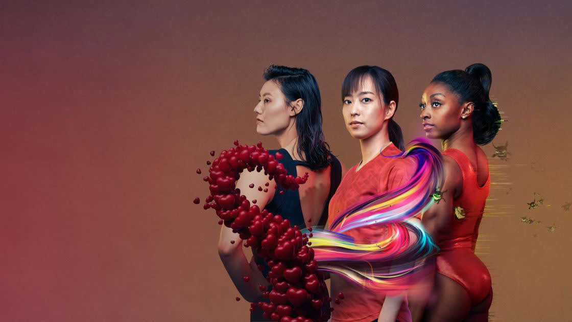 Three women stand side by side against a gradient background; the central figure is wrapped in a colorful ribbon-like swirl, with hearts emerging from the left side. All three wear serious expressions and athletic clothing.