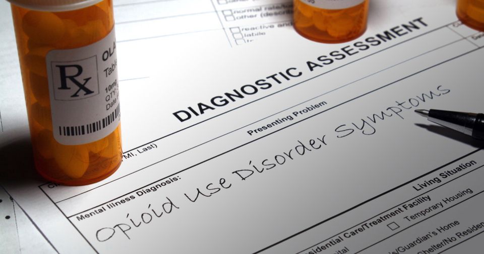 Stock image of a bottle of pills, and a diagnostic sheet with 