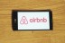 Airbnb logo on cellphone