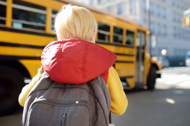 3 Pupil-with-schoolbag-with-yellow-school-bus-on-background