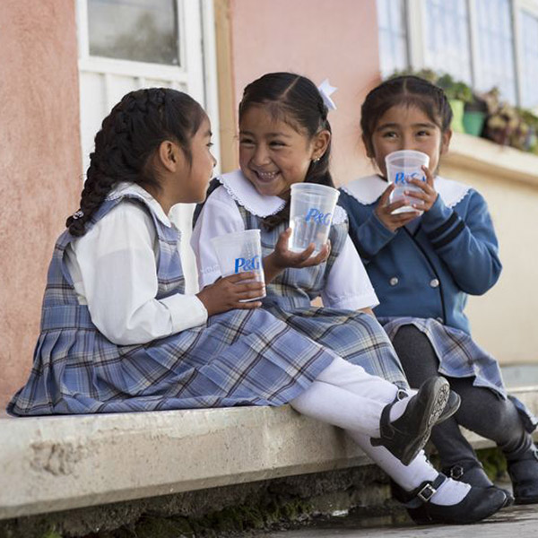 Children are smiling and drinking water
