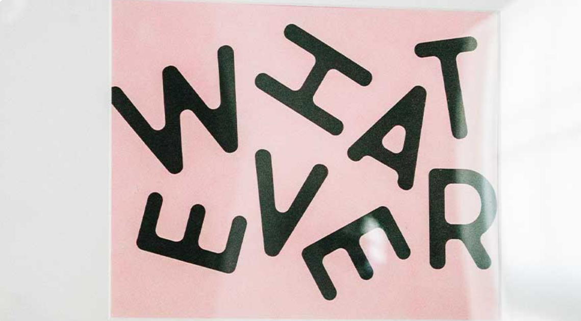 An image of an art piece with "whatever" styled in a zany way.
