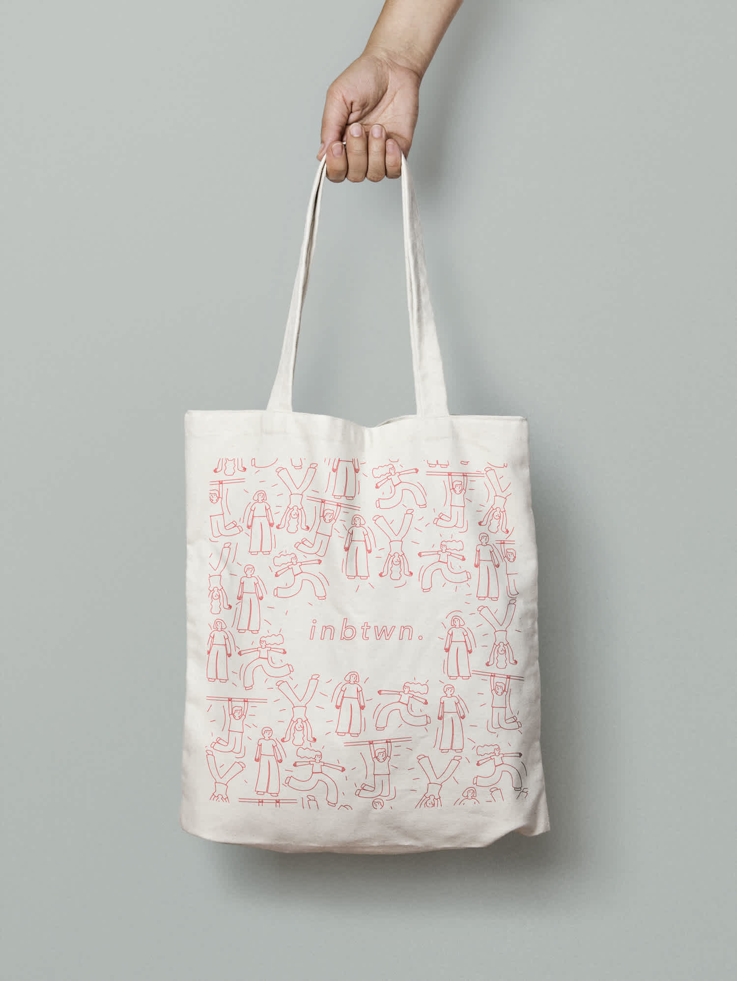 Canvas tote bag with design of drawn people with inbtwn. text in the middle