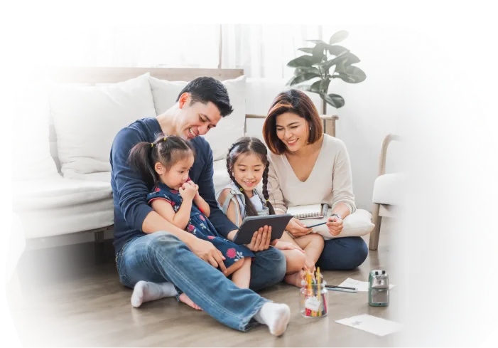 A family gathered in their living room, watching a tablet together