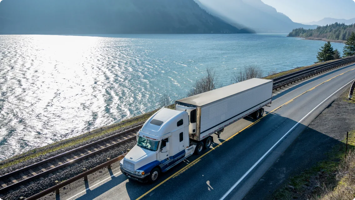 Large truck hauling a load on a coastal highway