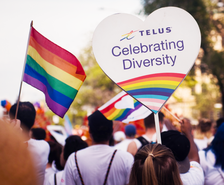 A TELUS Celebrating Diversity banner on display during a Pride parade