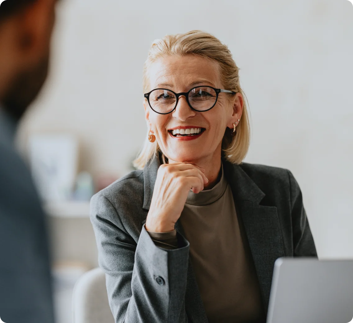 Professional women consulting another person with her laptop