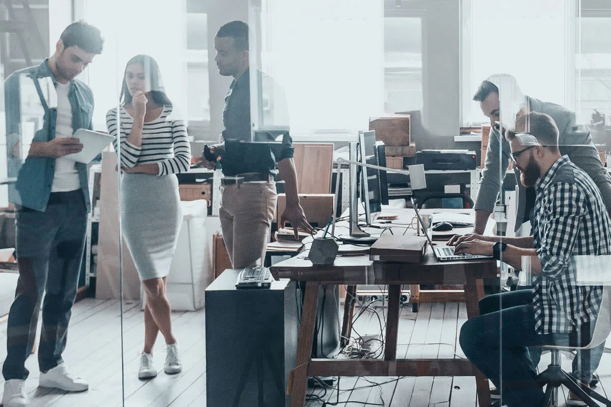 A modern, busy office with workers from different generations