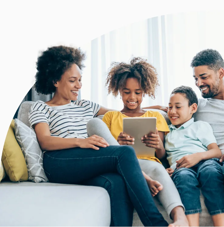 An image showing a family happily browsing through a tablet.