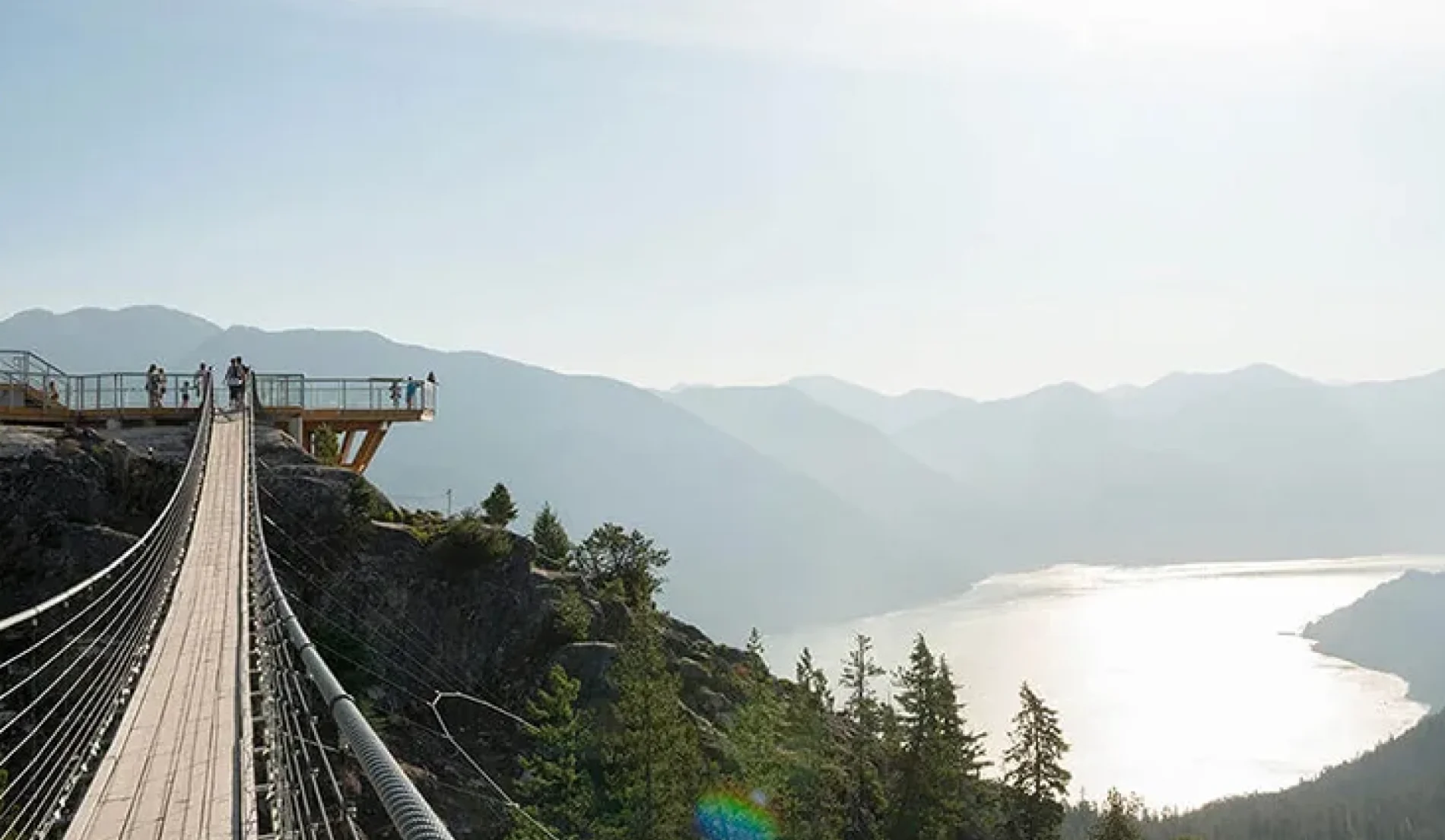 An image showing an overlooking of a river on a hanging bridge pathway.